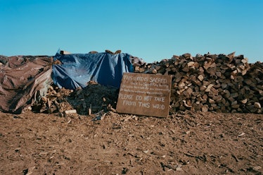 A pile of woods with a sign reading 'Please do not take from this wood' next to it.