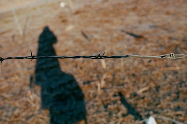 A shadow reflecting on a ground with barbed wire at Standing Rock
