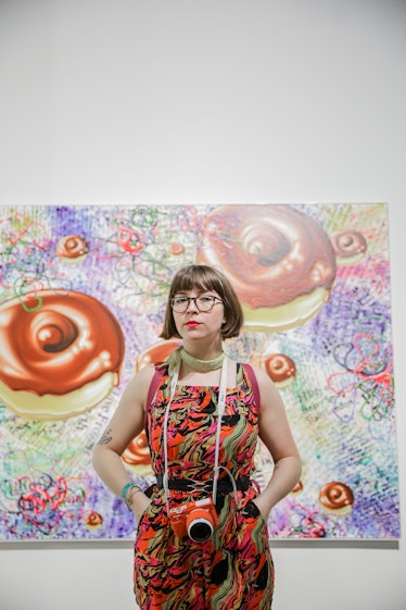 A woman posing in front of the artwork at Art Basel Miami Beach 2016.