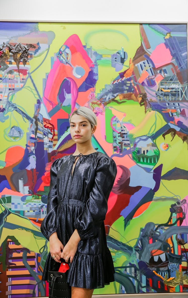 A woman in a black frilled dress at Art Basel Miami Beach 2016.