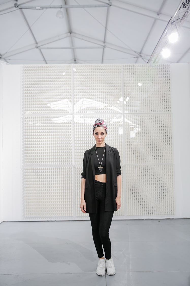 A woman wearing an all-black outfit posing at Art Basel Miami Beach 2016.