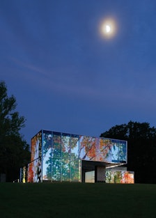 The house, activated by the artist Doug Aitken’s multifaceted projection *Lighthouse*, 2012.