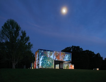 The house, activated by the artist Doug Aitken’s multifaceted projection *Lighthouse*, 2012.