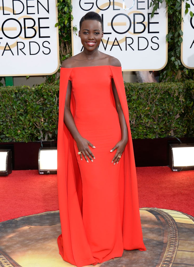 Lupita Nyong’o in an orange gown at the Golden Globe Awards red carpet event