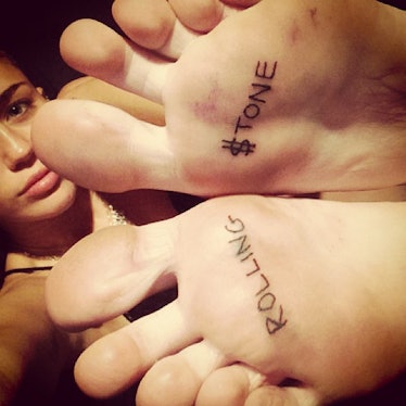 __#Inked:__ Cyrus has only to flash her feet—and her latest tattoo—to get people’s attention.