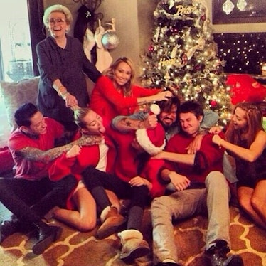 __#TBT:__ The day after Christmas, Cyrus shared this festive family snap—tongue included of course.