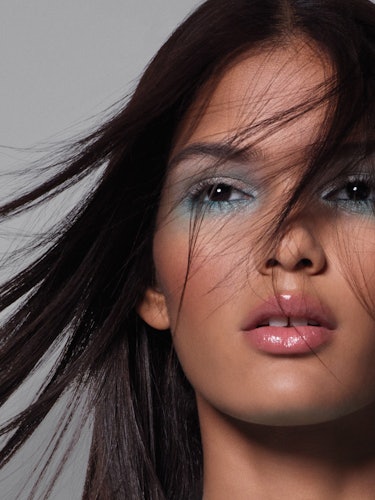 A brunette model with brown eyes and a blue smoky eye 
