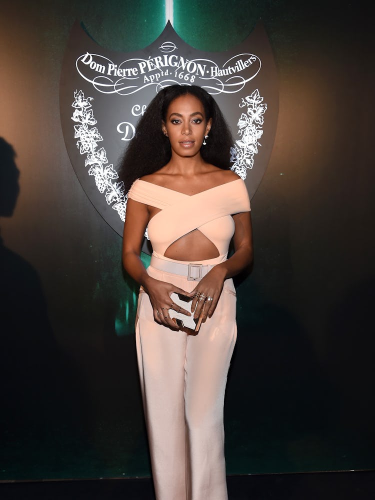 Solange Knowles posing while wearing a pink top and pants