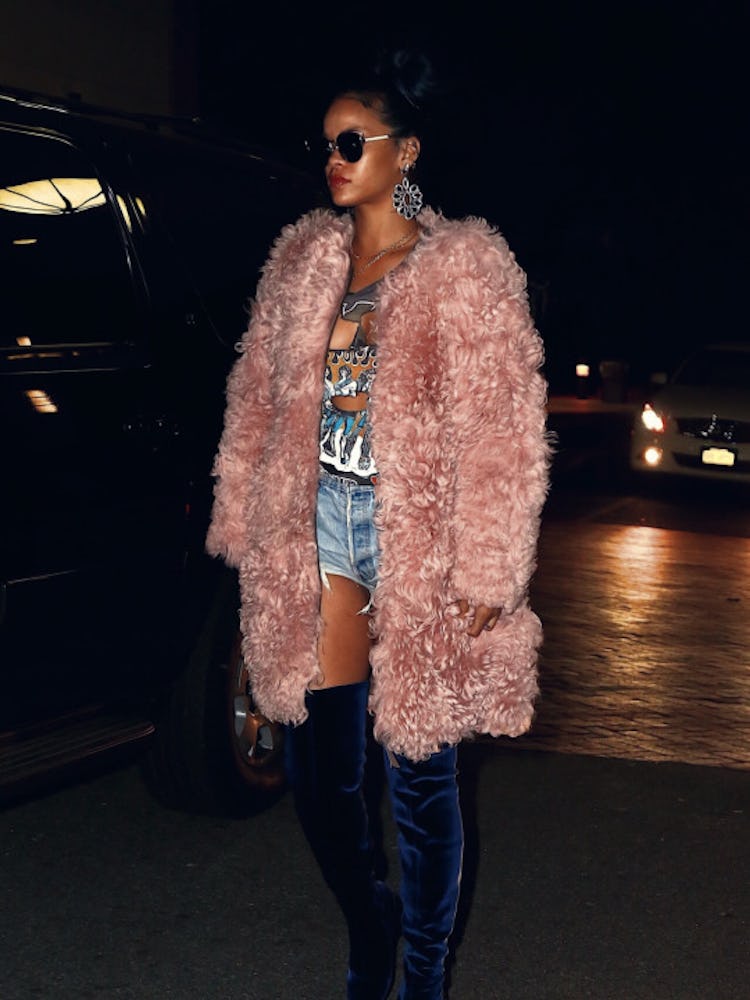 Rihanna walking while wearing a pink Kurt Geiger fur coat