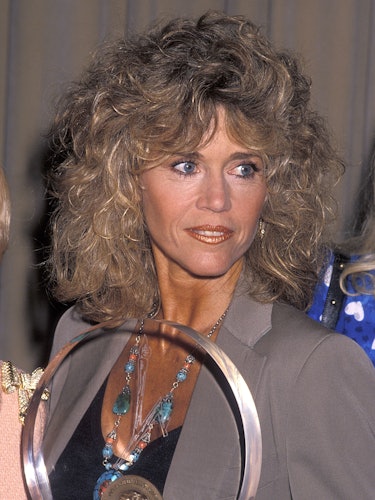 Jane Fonda with a metallic orange lip big hairstyle in 1990