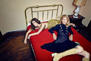 Theresa and Natasha lying on a red bed 