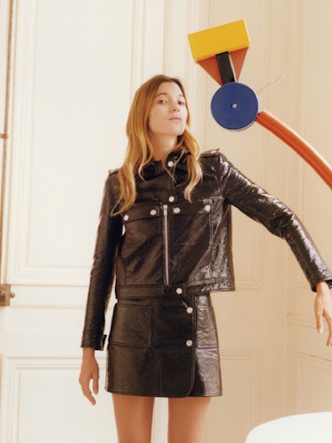 Lolita Jacobs wearing a Courrèges black leather jacket with a matching skirt