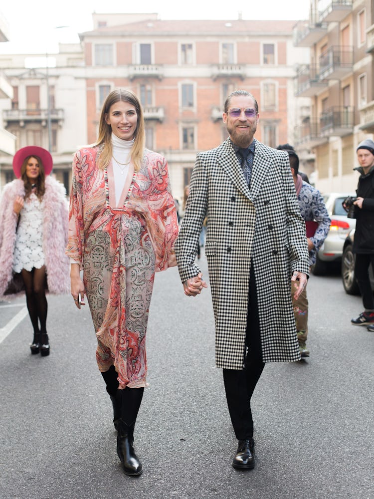 Justin O’Shea and Veronika Heilbrunner walking together outside the Etro show at Milan Fashion Week
