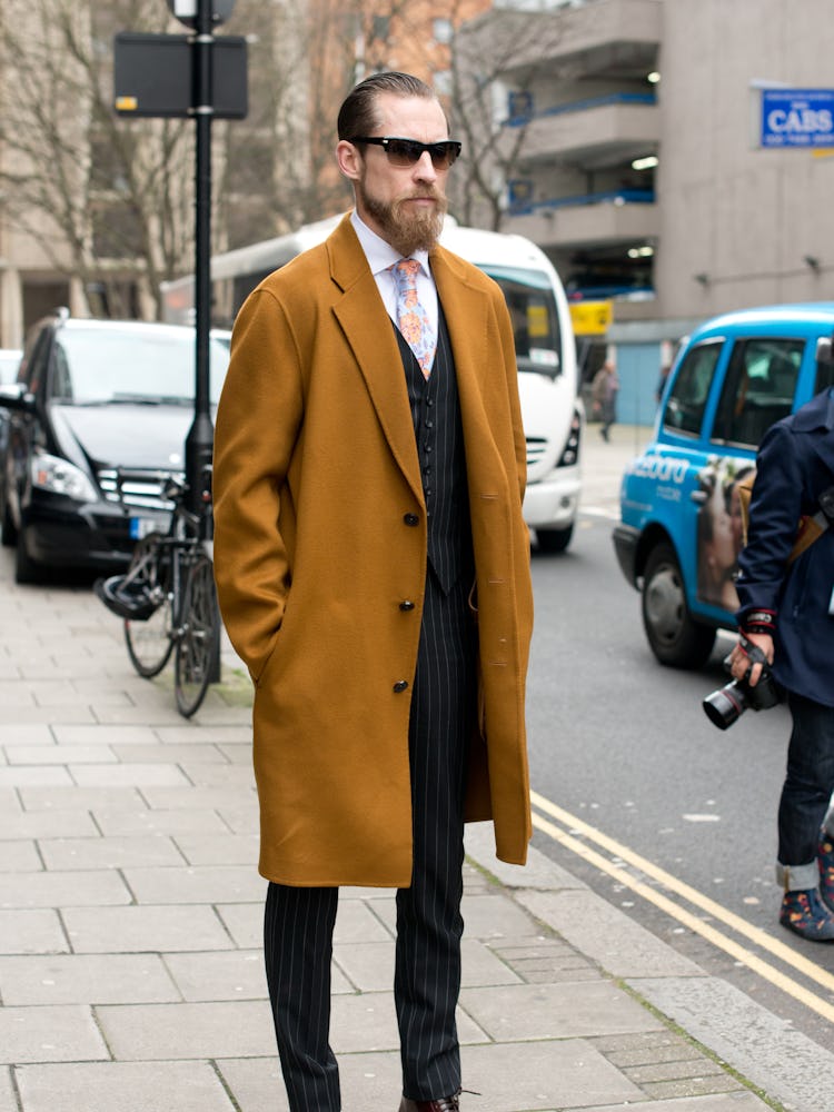 Justin O’Shea wearing a brown coat at the 2014 London Fashion Week