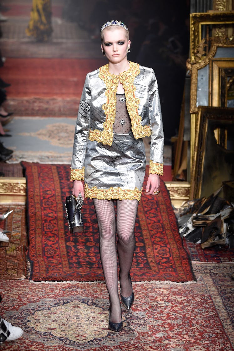 Ruth Bell wearing a Moschino satin gray skirt with a matching blazer, topped with embellished headba...
