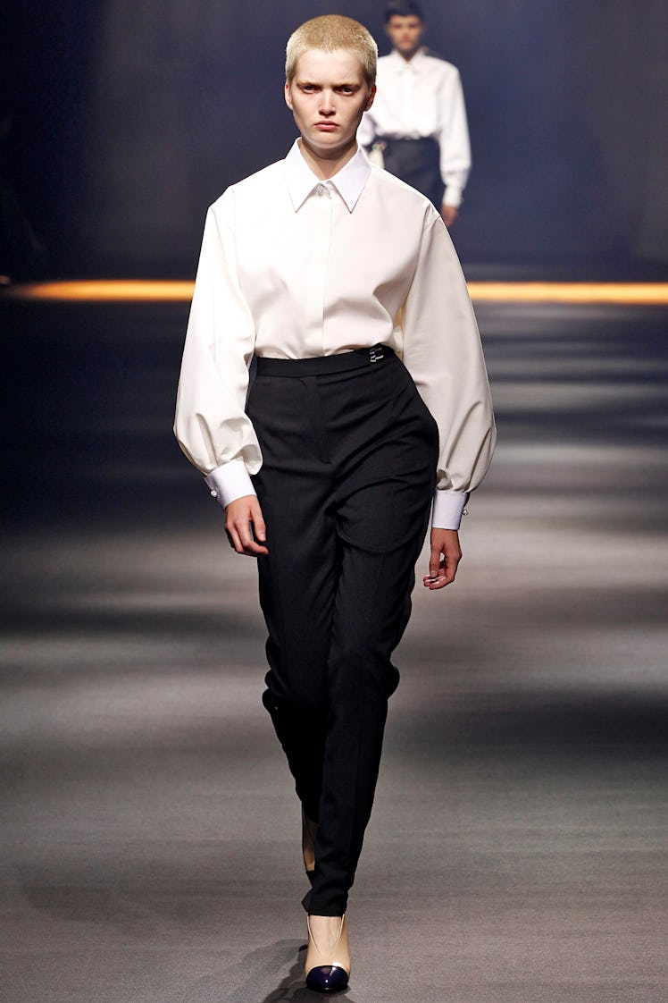 Ruth Bell walking in Lanvin black pants and white shirt at the Paris Fashion Week Spring 2016