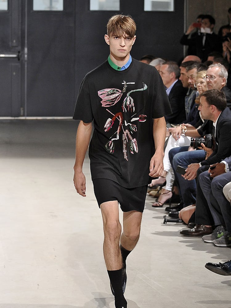 A model wearing Raf Simons' Spring 2014 look walking the runway in Paris