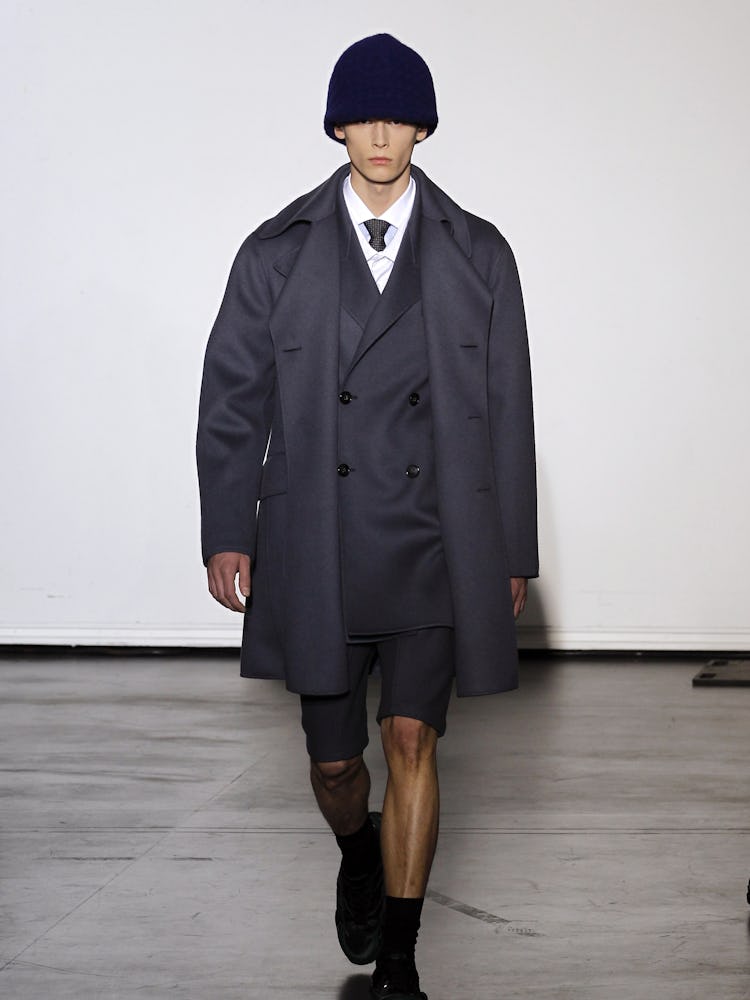 A model wearing a suit from Raf Simons' Fall 2012 fashion collection