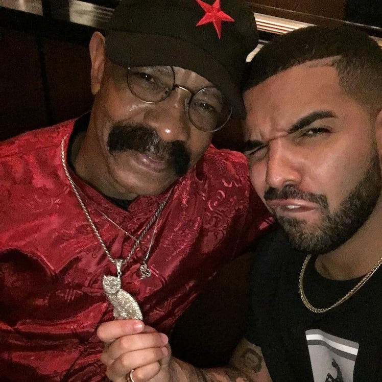 An Instagram selfie post with Dennis Graham in a red shirt and black cap posing with Drake next to h...