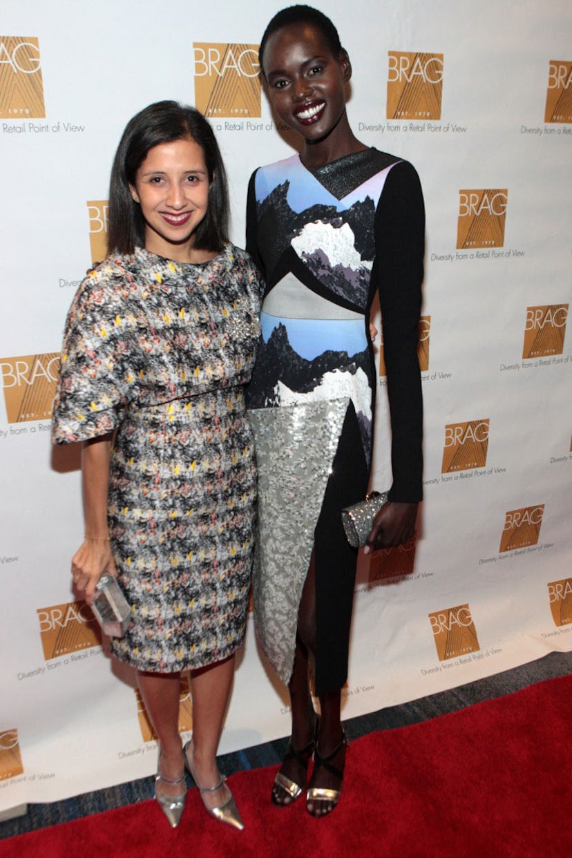 Karla Martinez de Salas and Ajak Deng accept an award for Edward Enninful