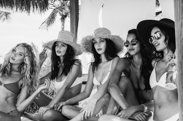 Models in bikinis posing for a photo, in black and white 