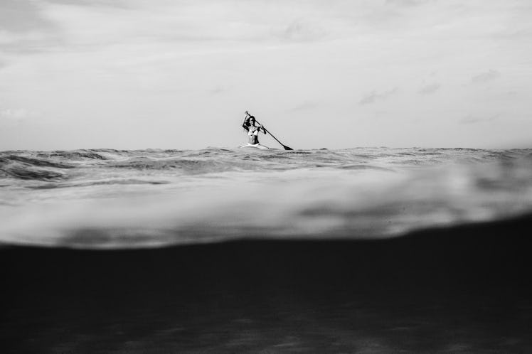 Model on a surfboard in black and white