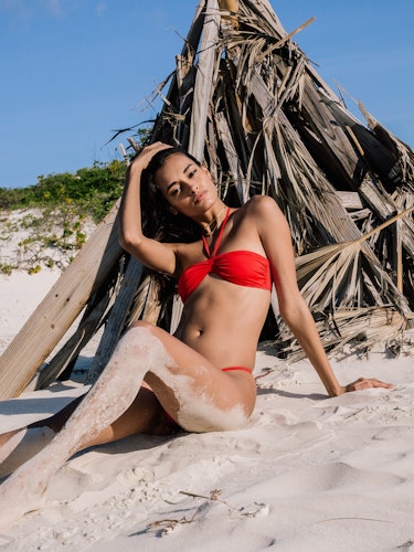 A model wearing an orange bikini posing for a series of photos from “Fyre Cay” in the Bahamas