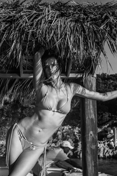 Alessandra Ambrosio posing under a parasol in black and white 