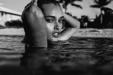 A female model standing in the water, in black and white