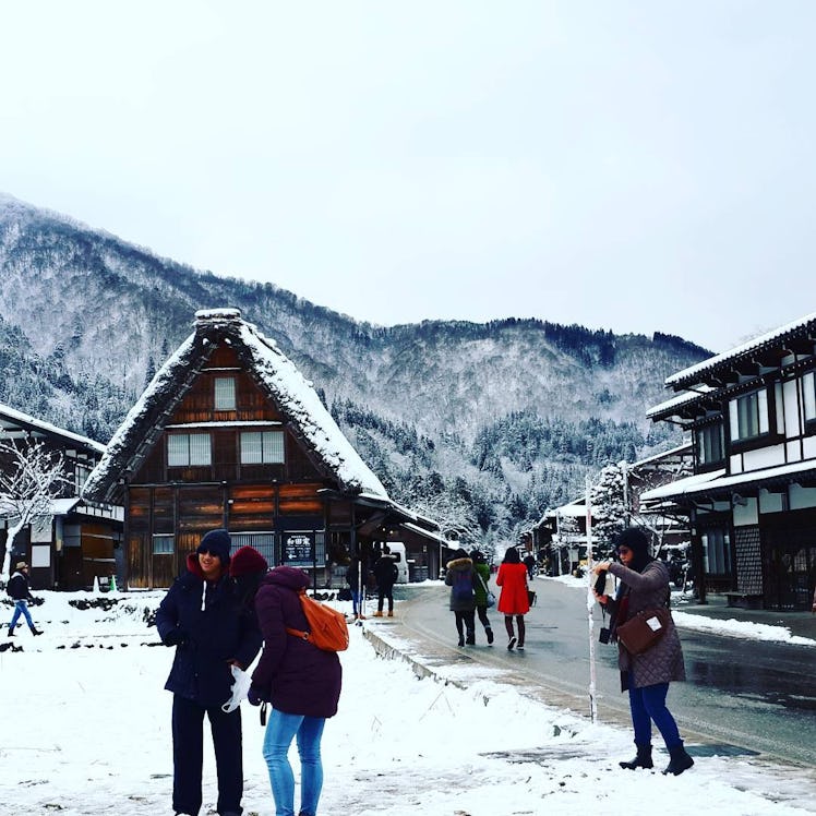 People walking in snowy Shirakawa Village in Japan