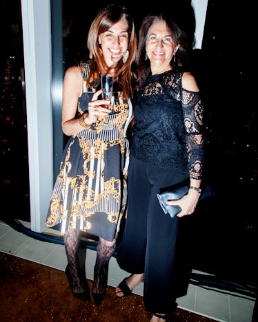 Two women posing for a photo and smiling at New Year’s Eve Blacktie Party at The Top of The Standard