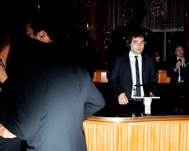 A man in a suit wearing headphones while playing at the New Year’s Eve Blacktie Party at The Top of ...