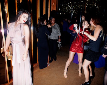 A woman in a beige gown getting her photo taken at New Year’s Eve Blacktie Party at The Top of The S...