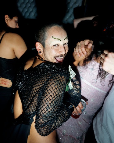A man with drawn on eyebrows in a black mesh top dancing at Ova the Rainbow : Dagger X OVA NYE