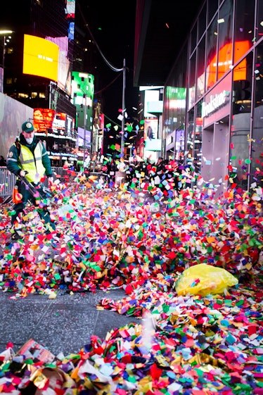 A person blowing off confetti after the celebration of New Year's Eve 2017