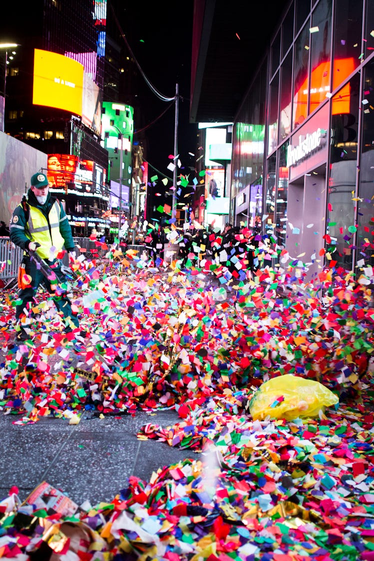 A person blowing off confetti after the celebration of New Year's Eve 2017