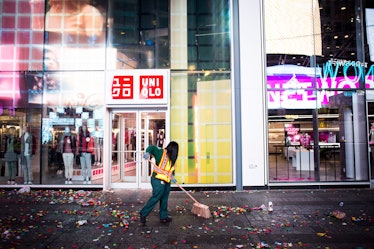 A cleaner removing confetti off the street at Times Square.