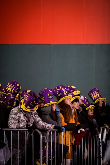 People gathered wearing matching hats for the New Year's Eve 2017 celebration at Times Square.