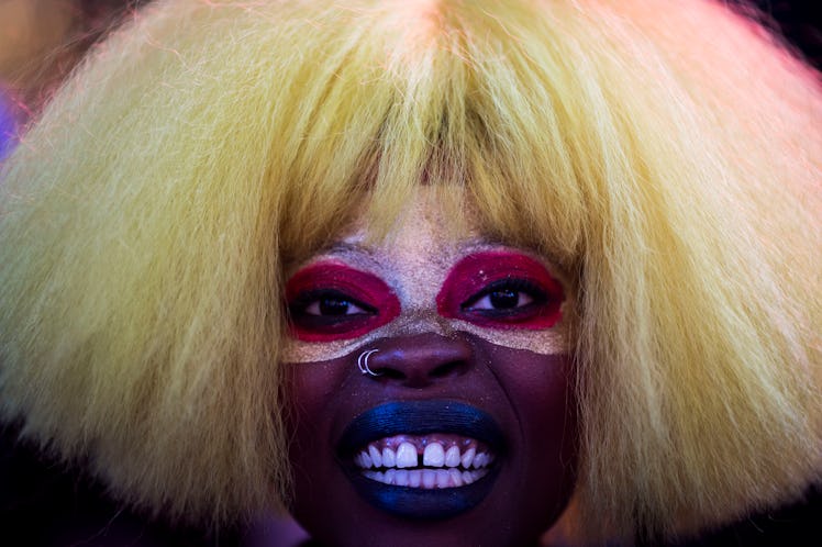 A woman with face paint and a blonde puffy wig celebrating New Year's Eve 2017 at Times Square.