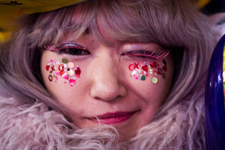 A woman wearing glitter makeup during New Year’s Eve 2017 celebration at Times Square.