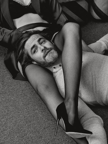 Chris Pine lying on the flower and a woman's legs wrapped around his neck