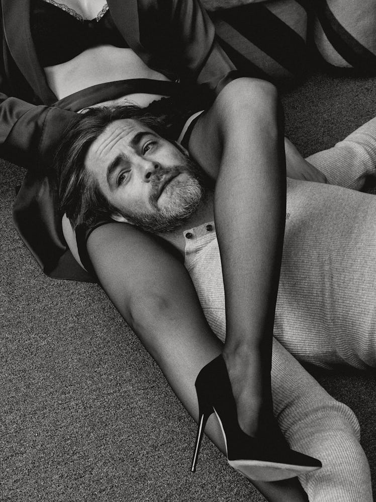 Chris Pine lying on the flower and a woman's legs wrapped around his neck