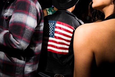 A man with his back turned in a black leather jacket with the American flag on it at W's Golden Glob...