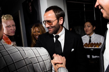 Tom Ford in a suit and tie shaking hands with someone at W's Golden Globes party 