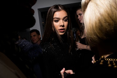 Hailee Steinfeld with a smoky eye and her hair straight talking to someone at W's Golden Globes Part...