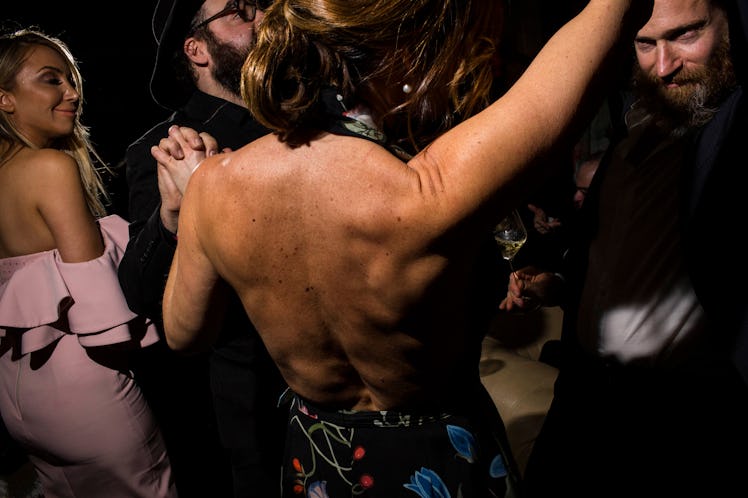 The back of a group of people dancing at W's Golden Globes party 