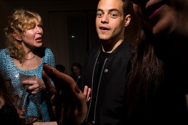 Rami Malek speaking to a group of people at W's Golden Globes party 