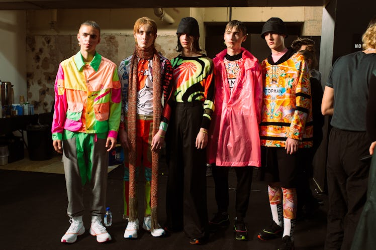 Five models posing for a photo while wearing colorful outfits 