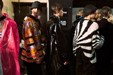6 models in colorful outfits standing in a queue