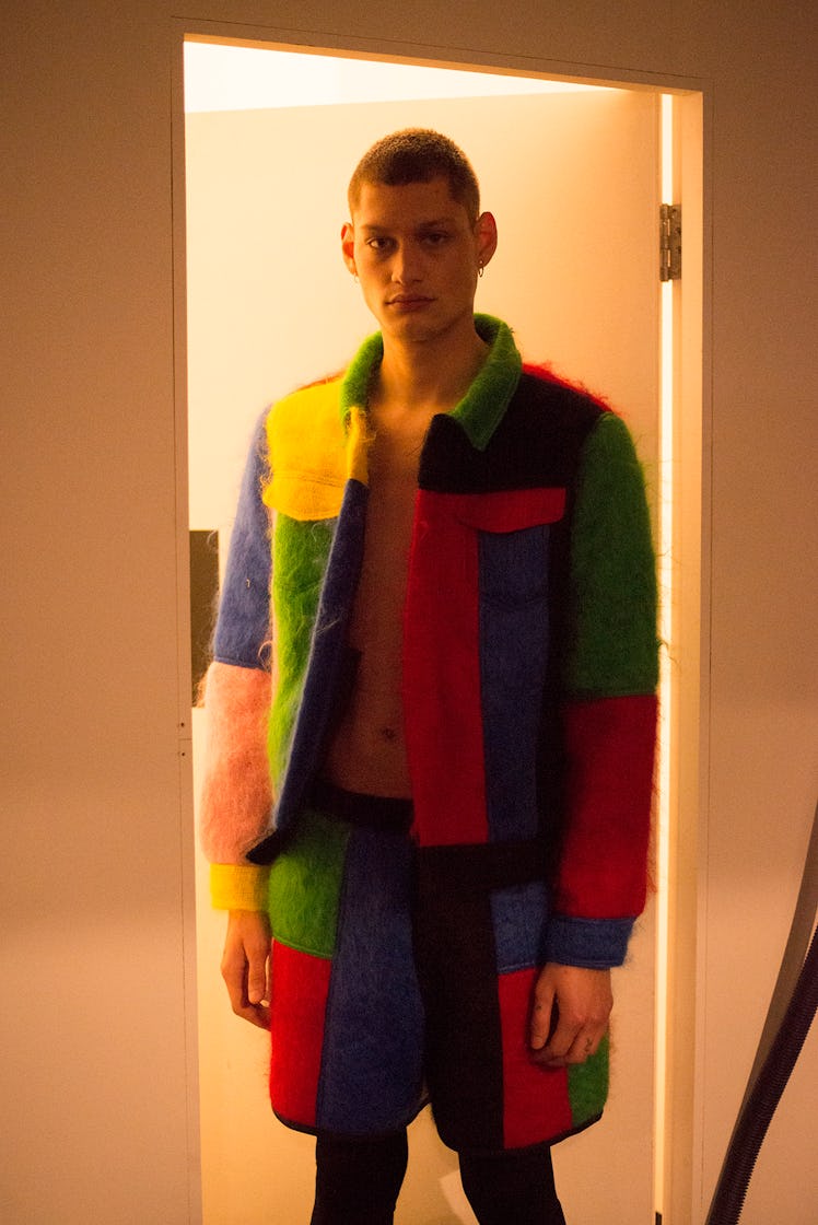 A male model wearing a matching color blocked jacket and shorts at London Fashion Week 